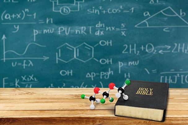 Equations on blackboard and Bible