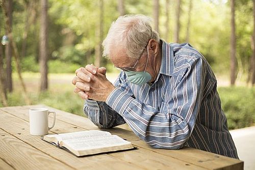 prayer bible mask older man 500x334